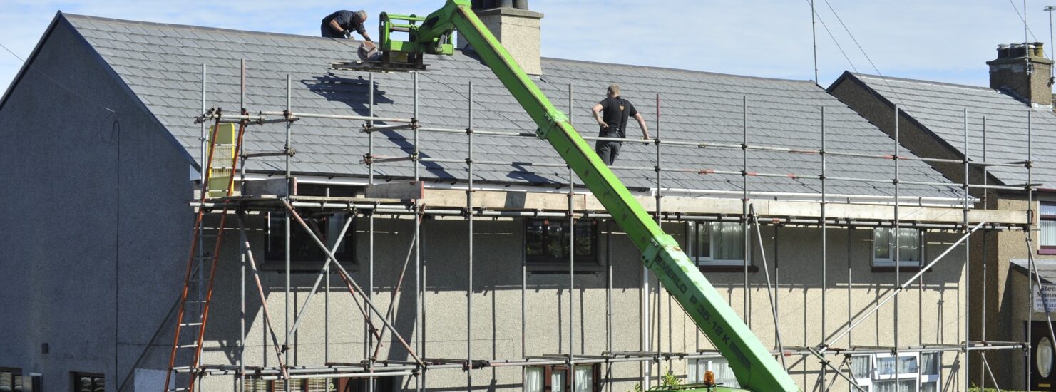 New Home Construction Costs men working on the roofing of the house